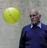 A person standing next to a ball

Description automatically generated